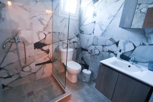 a bathroom with a toilet and a sink at Astri Villa in Ierissos +30 photos