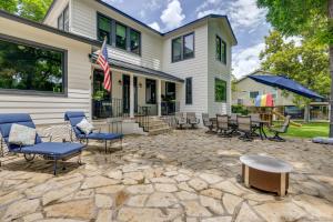 a patio with chairs and a table in front of a house at Spacious Lake Placid Retreat w/ Gorgeous Views! in Seguin