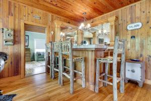 a kitchen with a bar and wooden walls and wooden floors at Spacious Lake Placid Retreat w/ Gorgeous Views! in Seguin