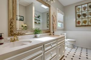 a bathroom with two sinks and a mirror at Spacious Lake Placid Retreat w/ Gorgeous Views! in Seguin +31 photos