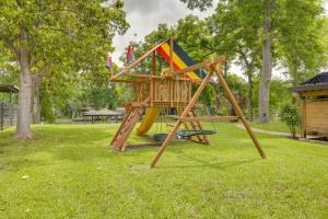 a wooden playground in a park with a slide at Spacious Lake Placid Retreat w/ Gorgeous Views! in Seguin
