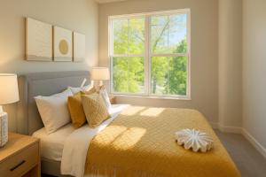 a bedroom with a bed and two windows at The Manor - Chevy Chase in Chevy Chase