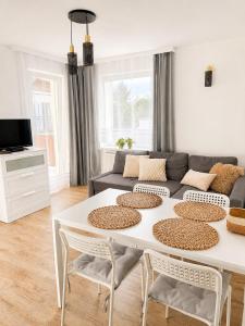 a living room with a white table and a couch at Dom Gościnny Ania in Wisełka