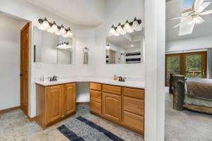 a bathroom with a sink and a mirror at Aces and Eights Lodge in Sturgis +20 photos