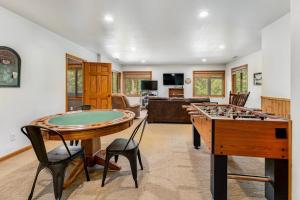 a living room with a ping pong table and a pool table at Aces and Eights Lodge in Sturgis