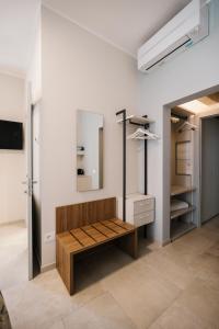 a dressing room with a bench and a mirror at Marinucci Rooms in Termoli
