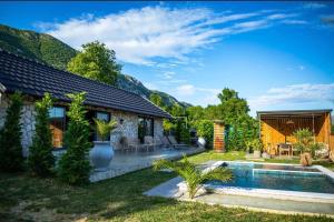 a backyard with a pool and a house at The Stonehouse in Ulcinj