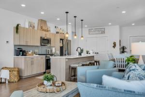 a kitchen and living room with blue chairs and a counter at Professionally managed 1 block to beach Coffee in Seaside Heights