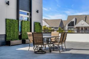 a patio with a table and chairs on a balcony at Professionally managed 1 block to beach Coffee in Seaside Heights