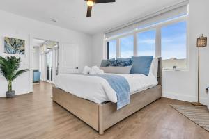 a bedroom with a large bed with blue pillows at Professionally managed 1 block to beach Coffee in Seaside Heights