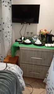 a television on top of a dresser in a bedroom at Soshanguve Lux Accom Room 03 in Soshanguve