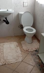 a bathroom with a white toilet and a sink at Soshanguve Lux Accom Room 03 in Soshanguve