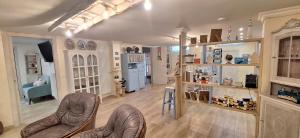 a living room with two chairs and a kitchen at Alessandra‘s House in Arezzo