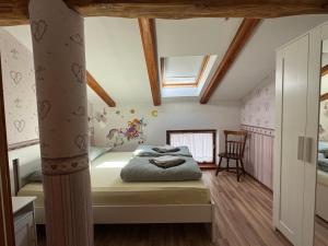 a bedroom with a bed in a room with wooden ceilings at Apartma na podeželju - Slovenia Nature in Kanal