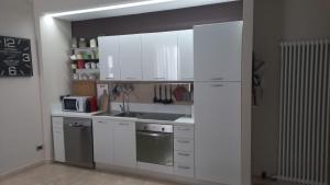 a kitchen with white cabinets and a sink at Corso Garibaldi in San Salvo