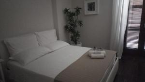 a bedroom with a white bed with a box on it at Corso Garibaldi in San Salvo