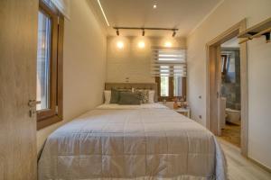 a bedroom with a large bed in a room at Lotza apartment Votsalo in Vrontádos +28 photos