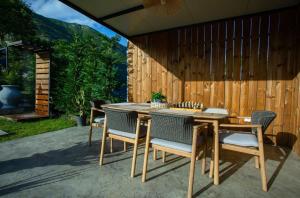 a patio with a wooden table and chairs at The Stonehouse in Ulcinj
