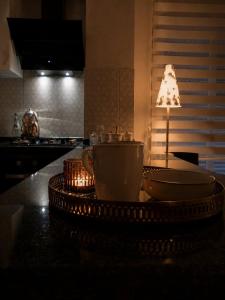 a kitchen counter with a table with a coffee cup on it at Metropolitan Art in Altınkum +100 photos
