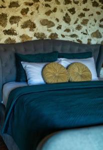 a blue bed with two pillows on top of it at The Stonehouse in Ulcinj +40 photos