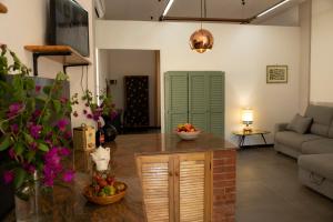 a living room with a table with a bowl of fruit at Marzasee - loft in Marzamemi