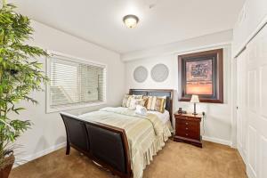 a bedroom with a bed and a dresser and a window at Salmon Run Condo - Overlooking the Spokane River in Post Falls