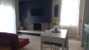 a living room with a white table and a fireplace at Corso Garibaldi in San Salvo