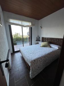 a bedroom with a bed and a large window at Mas Eucaliptus in Susqueda