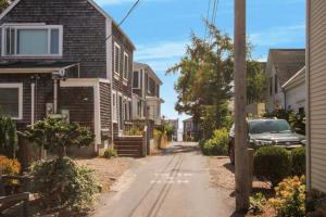 a street with houses and a car parked on the road at Harbor Hideaway in Provincetown