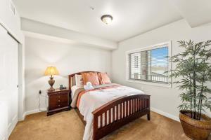 a bedroom with a bed and a potted plant at Salmon Run Condo - Overlooking the Spokane River in Post Falls