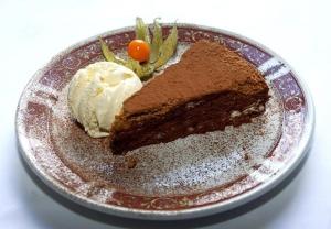 a piece of chocolate cake and ice cream on a plate at The Griffin Hotel in Attleborough