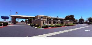 an empty parking lot in front of a building at Baymont by Wyndham Manteca in Manteca