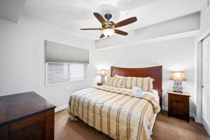 a bedroom with a bed and a ceiling fan at Riverside Condo - Gorgeous Spokane River View in Post Falls +20 photos