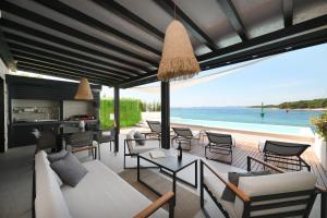 a living room with a view of the ocean at Luxury Feel Good House by the Sea with the Pool in Ždrelac