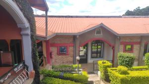 a model of a house with an orange roof at Madina Homes in Butare