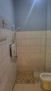 a bathroom with a shower and a toilet at Madina Homes in Butare