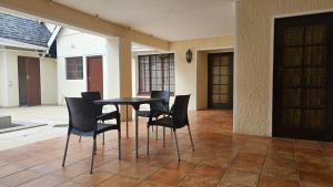 a black table and chairs in a patio at 3D Power guest house in Durban