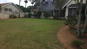 a yard in front of a house at 3D Power guest house in Durban