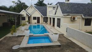 a swimming pool in the backyard of a house at 3D Power guest house in Durban +10 photos