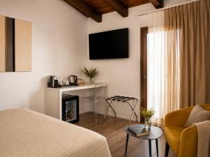 a living room with a bed and a fireplace at Astra - Exclusive Rooms in Castelsardo