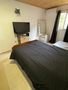 a bedroom with a bed and a flat screen tv at Departamento norte interno in Rafaela