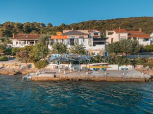 a view of a resort from the water at Apartments on island Molat next to the sea - by TA Leut Agency in Brgulje