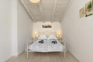 a bedroom with a bed in a white room at Apartments on island Molat next to the sea - by TA Leut Agency in Brgulje