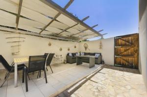 a patio with a table and chairs and a couch at Apartments on island Molat next to the sea - by TA Leut Agency in Brgulje
