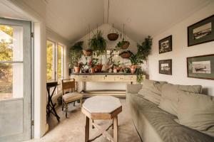 a living room with a couch and a table at Harvest Cottage Blue Mountains in Leura