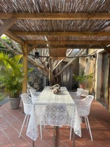 a table and chairs under a wooden pergola at Cottage on the Beach in Taormina +22 photos