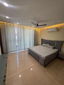a bedroom with a bed and a large window at Third Pole in Kathmandu