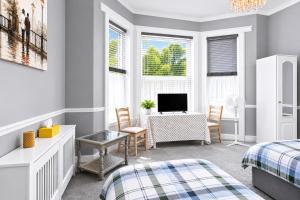 a bedroom with two beds and a desk with a computer at Spacious two bedroom flat in Lansdowne in Bournemouth