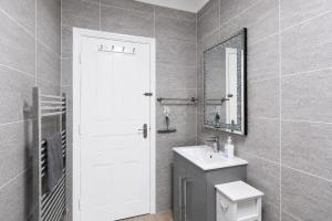 a bathroom with a toilet and a sink and a mirror at Spacious two bedroom flat in Lansdowne in Bournemouth