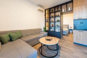 a living room with a couch and a table at Rezevici Horison View Apartment in Reževići